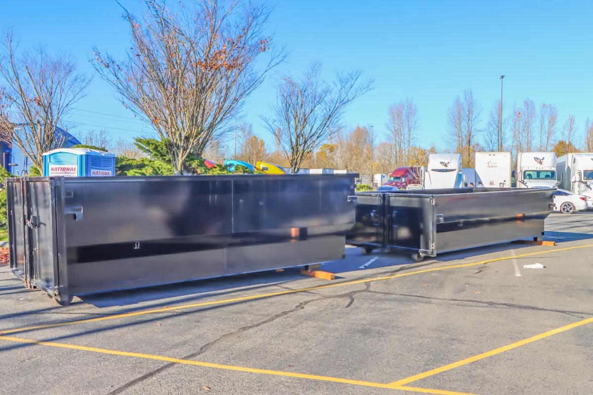 Professional dumpster rental service with roll-off container on residential driveway in CaÃ±on City